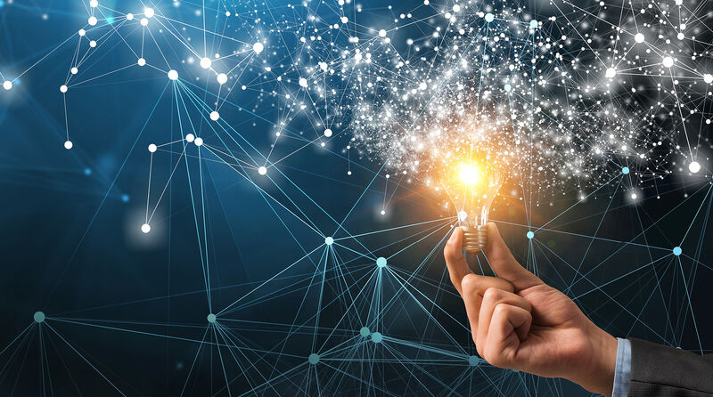 Offizielles Kampagnenvisual des Ideenwettbewerbs: Eine Hand hält eine leuchtende Glühbirne, von der ein ausgedehntes, leuchtendes Netzwerk aus Verbindungen und Lichtpunkten ausgeht.